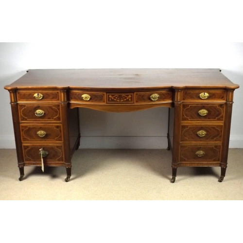 910 - An Edwardian mahogany bow fronted desk, attributed to Gillows, Lancaster, previously a dressing tabl... 