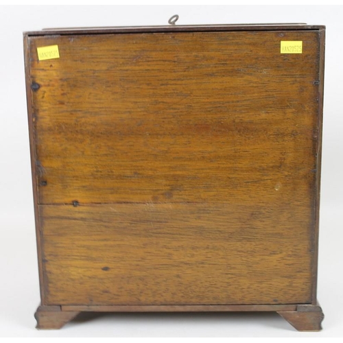 910A - An Edwardian mahogany apprentice bureau, the fall flap opening to reveal recesses, above two short a... 