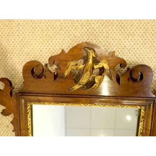 911A - A Georgian mahogany fretwork wall mirror, with gilt ho ho bird surmount, rectangular plate and gilt ... 