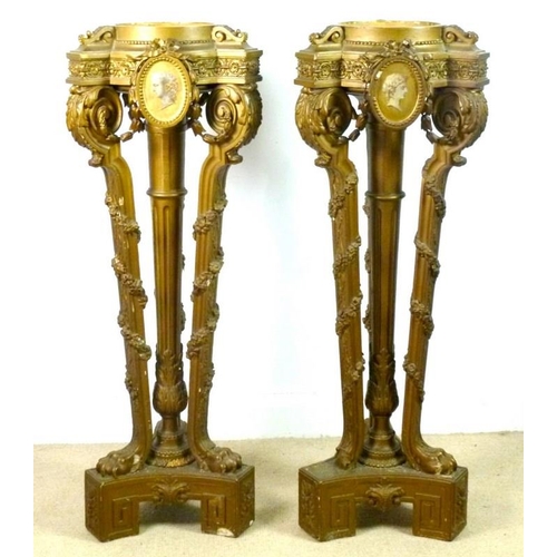 916 - A pair of Victorian jardiniere stands, the tops with painted portrait plaques, raised on a central c... 