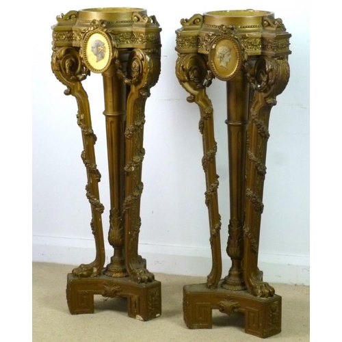 916 - A pair of Victorian jardiniere stands, the tops with painted portrait plaques, raised on a central c... 