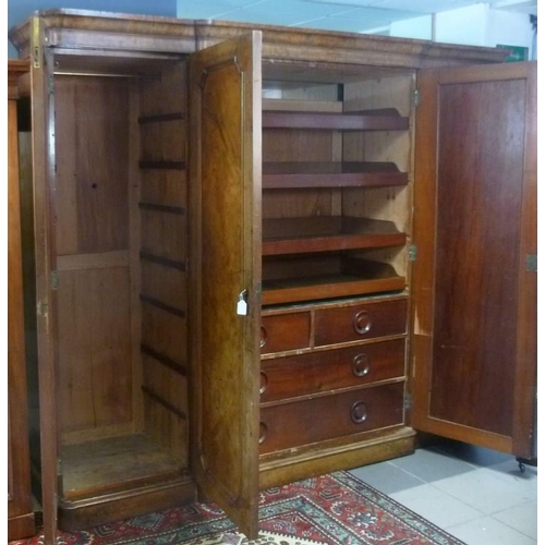 918 - A Victorian walnut break front compactum wardrobe, the central doors enclosing three slides above tw... 