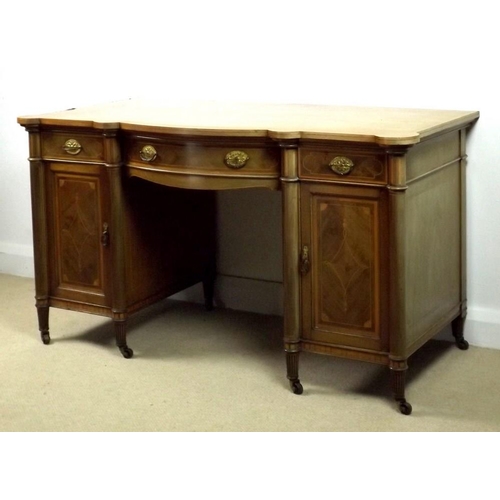 920 - An Edwardian mahogany bow and break fronted desk, attributed to Gillows, Lancaster, with satinwood c... 