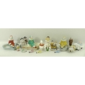 A collection of ceramic figures, comprising a Limoges pepperette, modelled as a Pierrette, 7cm, thre... 