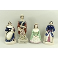 A pair of Staffordshire figures of Queen Victoria, seated with baby Princess Royal, and Prince Alber... 