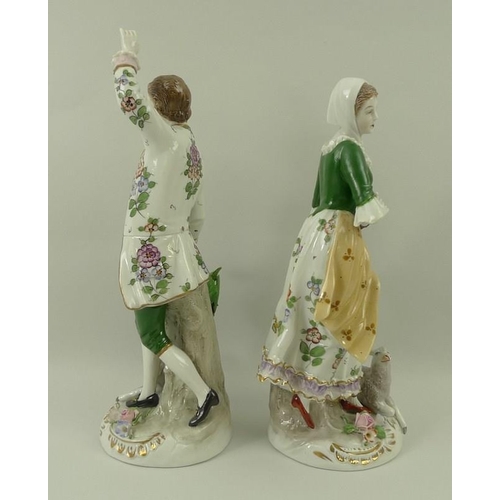 501 - A pair of Sitzendorf figurines, modelled as a girl with a tambourine and sheep, and a dancing man wi... 