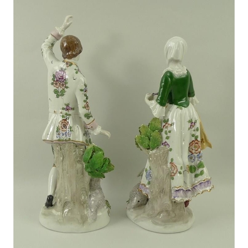 501 - A pair of Sitzendorf figurines, modelled as a girl with a tambourine and sheep, and a dancing man wi... 