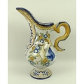 An Italian Albarello jug in yellow and blue glazes, decorated with putti, 22cm.