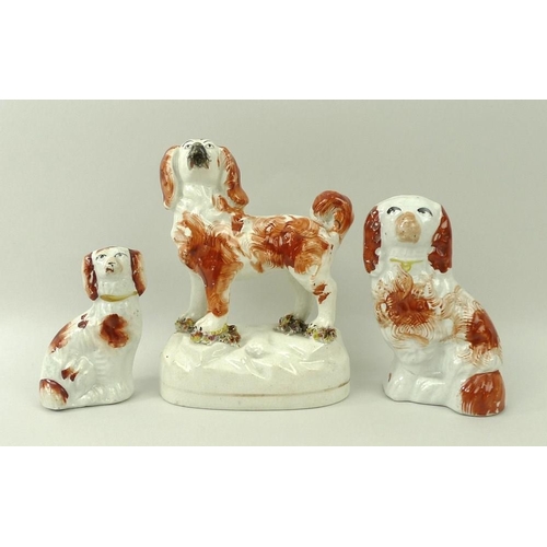 510A - A Staffordshire ceramic figure of a King Charles spaniel, standing with bocage at feet, 13cm, togeth... 