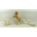 A Beswick figure of a Palomino horse, rearing, marked to the base and numbered 1014, 27cm high, toge... 