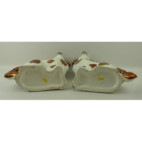526 - A pair of Staffordshire flatbacks of King Charles spaniels, in copper lustre, 32cm.