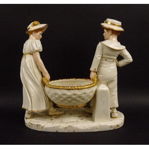 530A - A Royal Worcester ivory porcelain figural group, of a girl and boy holding a basket, with gilded hig... 