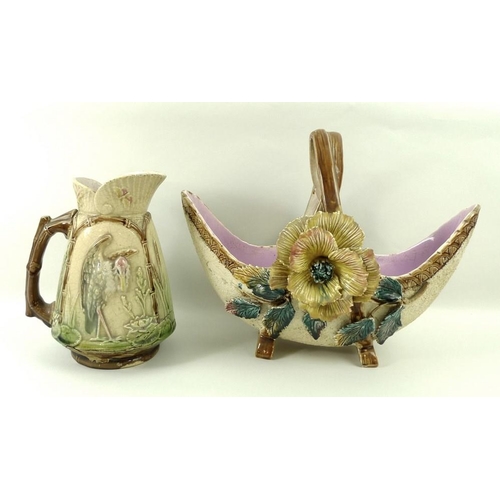 531 - A Majolica basket decorated with roses, 30 by 25cm, and a Majolica jug decorated with storks fishing... 