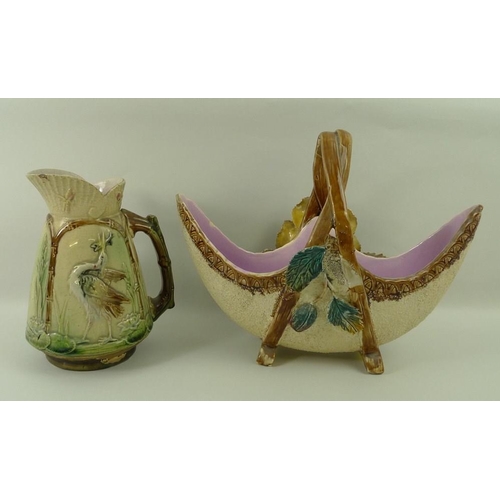 531 - A Majolica basket decorated with roses, 30 by 25cm, and a Majolica jug decorated with storks fishing... 