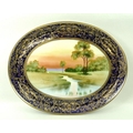 A Japanese Noritake porcelain oval tray, 20th century, hand painted with a river landscape, 33 by 26... 