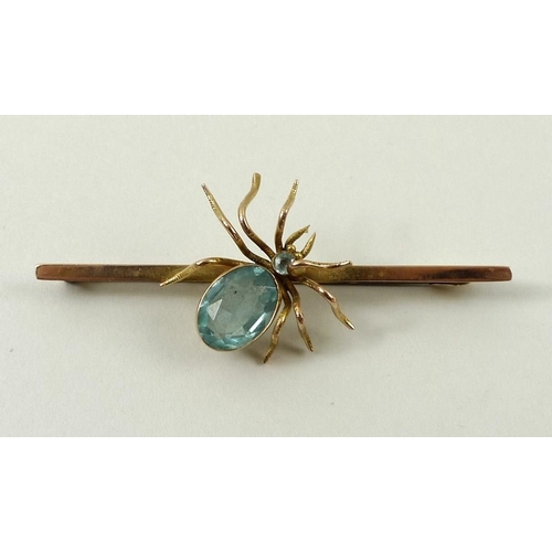 791 - A 9ct gold bar brooch, circa 1910, set with a spider with aquamarine body and head, 4g.