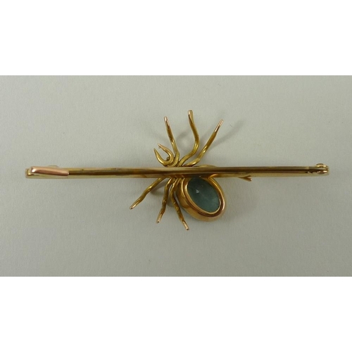 791 - A 9ct gold bar brooch, circa 1910, set with a spider with aquamarine body and head, 4g.