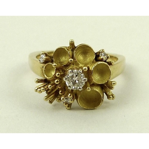 800 - An 18ct gold, diamond and enamel dress ring, in the form of a buttercup, the central diamond of appr... 