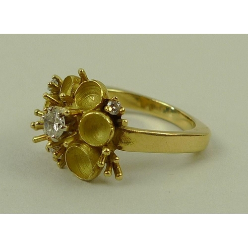 800 - An 18ct gold, diamond and enamel dress ring, in the form of a buttercup, the central diamond of appr... 