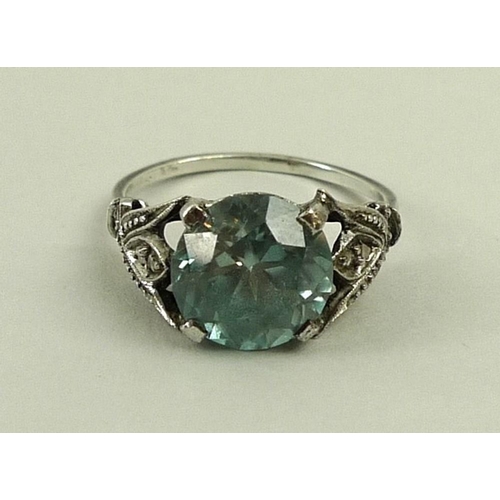 803 - An Art Deco aquamarine and diamond dress ring, the trefoil shoulders each set with five diamonds, wi... 