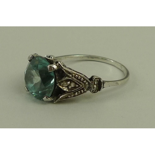 803 - An Art Deco aquamarine and diamond dress ring, the trefoil shoulders each set with five diamonds, wi... 