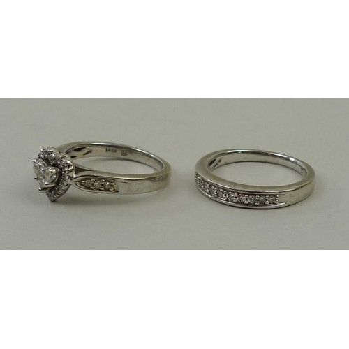 810 - A 14kt white gold half eternity ring, set with eleven diamonds, and a matching 14kt and diamond ring... 