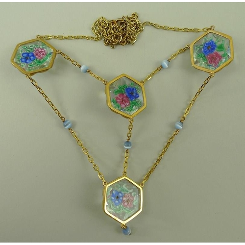 811 - A 9ct gold, cats eye sapphire and caned glass necklace, the four hexagonal glass pendants each with ... 