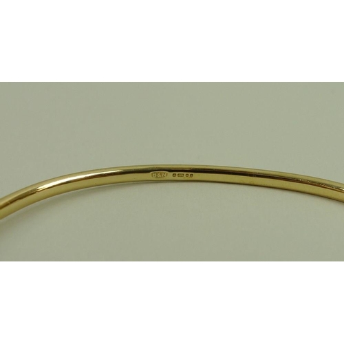 812 - A 9ct gold bangle, London 1993, maker B & N, 12.4g.