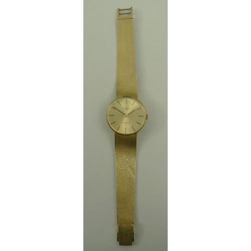 813 - A gentleman's Rotary 9ct golf wristwatch, the circular face with baton numerals, with textured gold ... 