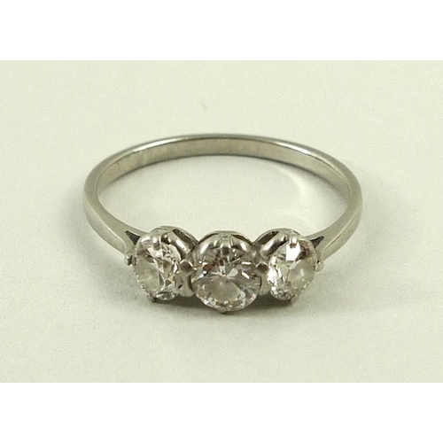 814 - A three stone diamond ring, approximate total 0.5ct, on a white metal band, size O.