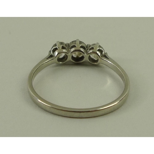 814 - A three stone diamond ring, approximate total 0.5ct, on a white metal band, size O.