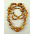 A 1920s string of graduated vintage amber beads, 84cm, 51.7g.