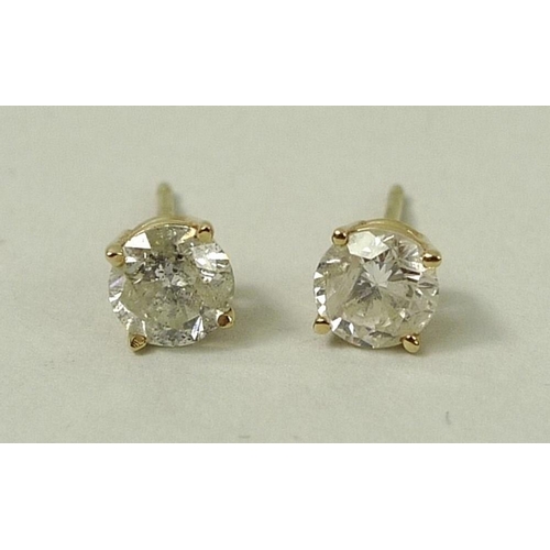 828 - A pair of 14ct gold and diamond ear studs, the brilliant cut diamonds each of approximately 0.5ct, 1... 