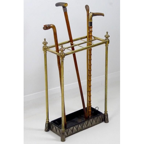 833 - A Victorian brass eight division stick stand, turned finials and plain columns, the cast metal base ... 