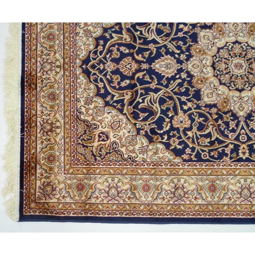 834 - A Keshan rug with dark blue ground, central cream medallion, dense field with scrolling decoration, ... 