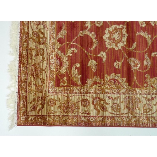 836 - A Ziegler rug, with red ground and gold foliate decoration, 230 by 160cm.