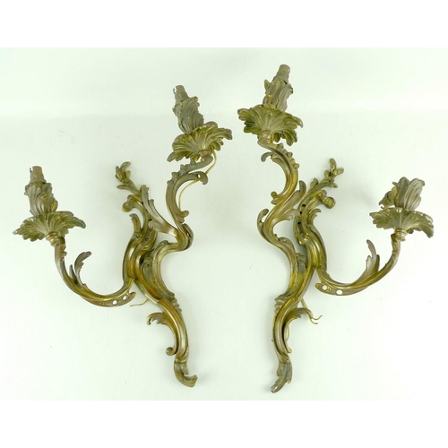 840 - A pair of gilded brass twin arm wall sconces with acanthus leaf decoration, 32 by 46cm high. (2)