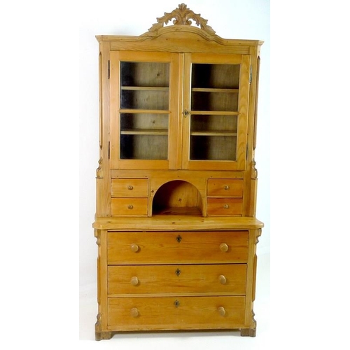 845 - A Continental pine dresser, with carved shaped cornice, twin glazed doors enclosing two shelves, fou... 