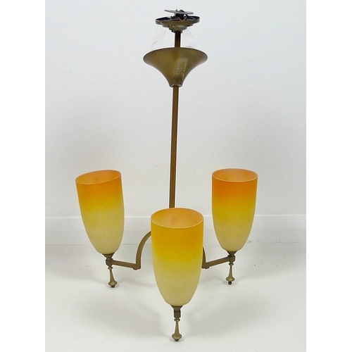 847 - An Art Deco brass hanging light, with three orange glass shades, 40 by 65cm high.