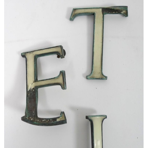 854 - A collection of enamel and bronze shop sign letters, early 20th century, cream enamel, 15cm. (27)