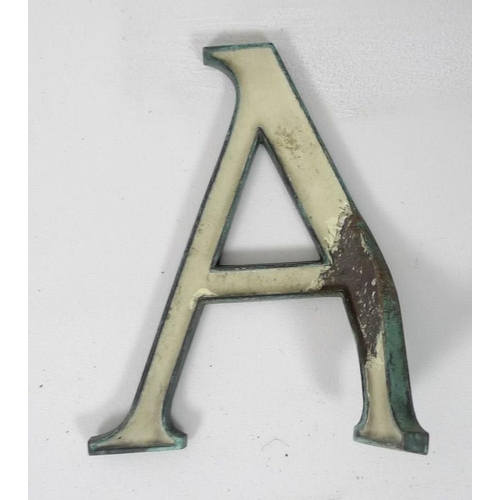 854 - A collection of enamel and bronze shop sign letters, early 20th century, cream enamel, 15cm. (27)