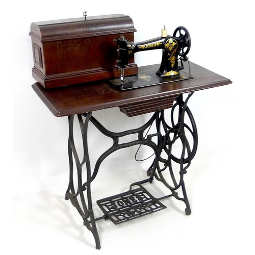 858 - An early 20th century Jones & Co sewing machine, decorated in black with gold painted highlights, on... 