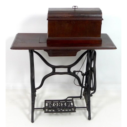 858 - An early 20th century Jones & Co sewing machine, decorated in black with gold painted highlights, on... 