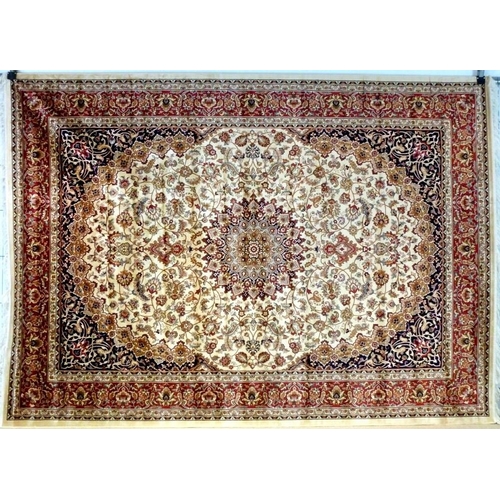 860 - A Keshan rug with beige ground, central star medallion, dark blue corners and scrolling foliate fiel... 