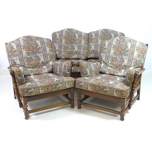 862 - An Ercol dark stained 'Old Colonial' three piece suite, comprising a two seater sofa, 160 by 95 by 9... 