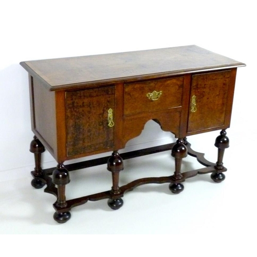 863 - A Jacobean style server sideboard, mid 20th century, with quarter veneered surface, two cupboards fl... 