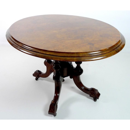 907 - A Victorian burr walnut loo table, with oval tilt top burr walnut surface, deeply moulded edge, rais... 