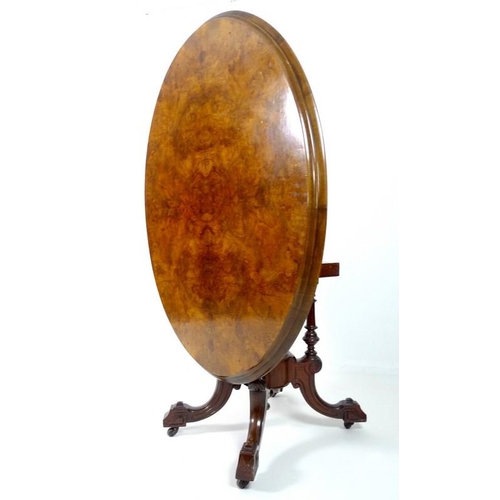 907 - A Victorian burr walnut loo table, with oval tilt top burr walnut surface, deeply moulded edge, rais... 