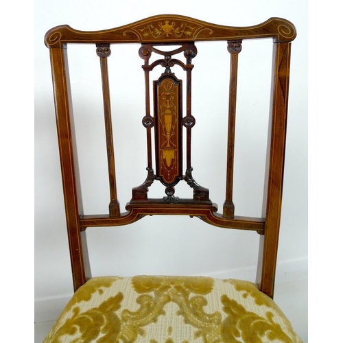 909 - Four Edwardian mahogany and marquetry inlaid salon chairs, the pierced splats intricately formed wit... 