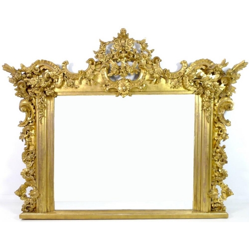 910 - A giltwood and composite overmantel mirror, late 18th century and later, in Rococo style frame with ... 